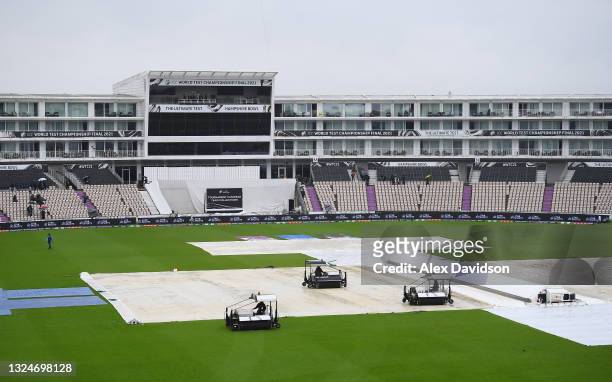Groundstaff work on the covers as play is delayed on Day 4 of the ICC World Test Championship Final between India and New Zealand at The Hampshire...