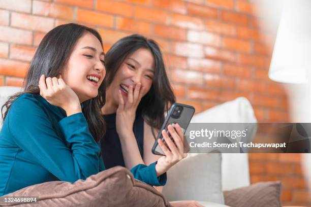 two young asian female women friends sharing happy time together - a teen thai stock pictures, royalty-free photos & images