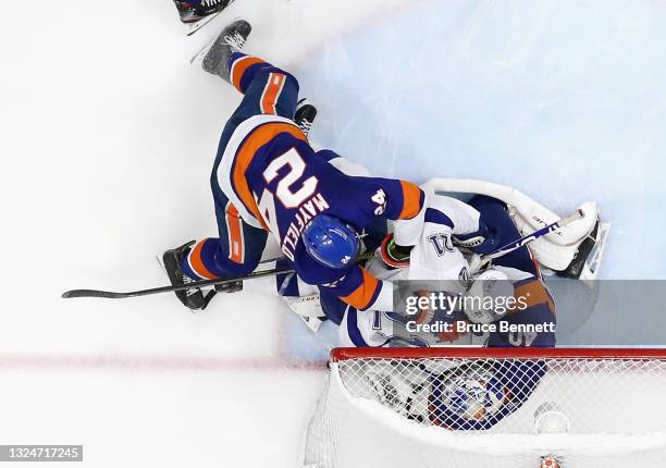 Scott Mayfield of the New York Islanders checks Brayden Point of the Tampa Bay Lightning into Semyon Varlamov in Game Four of the Stanley Cup...