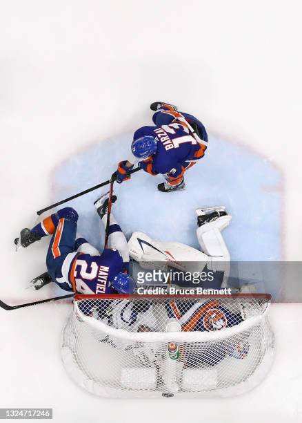Scott Mayfield of the New York Islanders checks Brayden Point of the Tampa Bay Lightning into Semyon Varlamov in Game Four of the Stanley Cup...