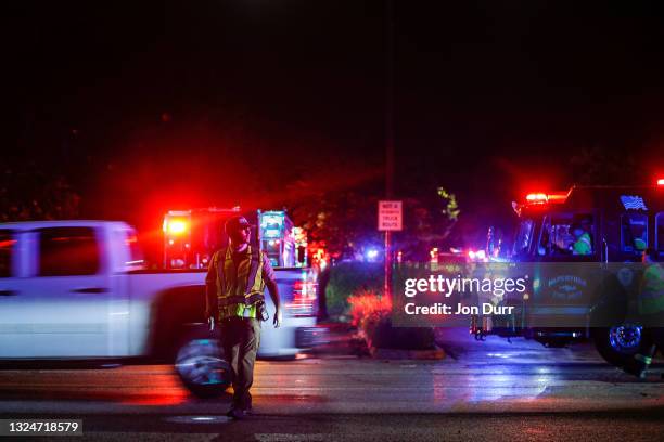 Emergency crews direct traffic at the intersection of Ranchview Drive and 75th Street after a tornado came through the area on June 21, 2021 in...