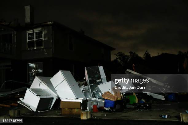 Debris is piled up after a garage was destroyed on the 7500 block of Gladstone Drive on June 21, 2021 after a tornado came through the area in...