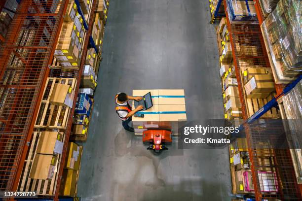 top view of warehouse worker using laptop to check location of goods. - manufacturing technology bildbanksfoton och bilder