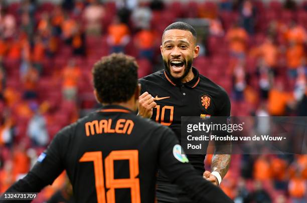 Memphis Depay of Netherlands celebrates with teammate Donyell Malen after scoring their side's first goal during the UEFA Euro 2020 Championship...
