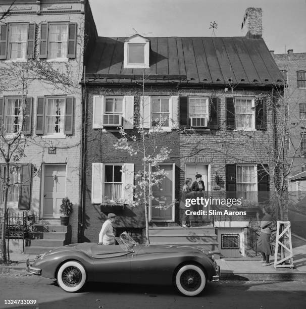 Jaguar XK 120 sports car, parked in a suburban street, circa 1955.