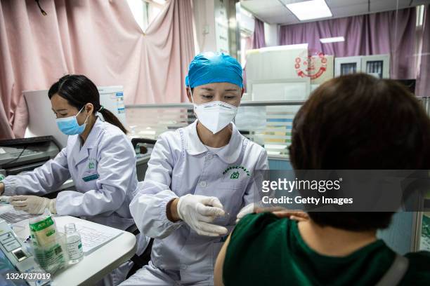 The medical worker administers a dose COVID-19 vaccine to resident at a community health service on June 21, 2021 in Wuhan, China. As of last month,...