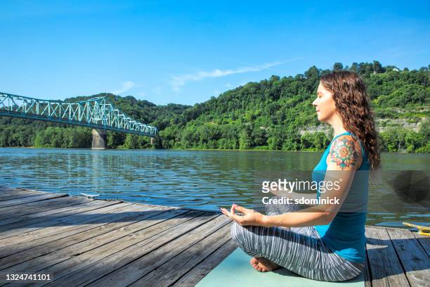 frau macht yoga von river - ohio river stock-fotos und bilder