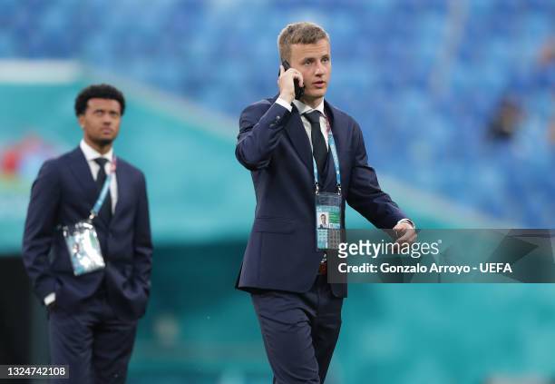 Robert Ivanov of Finland speaks on the phone as he inspects the pitch prior to the UEFA Euro 2020 Championship Group B match between Finland and...