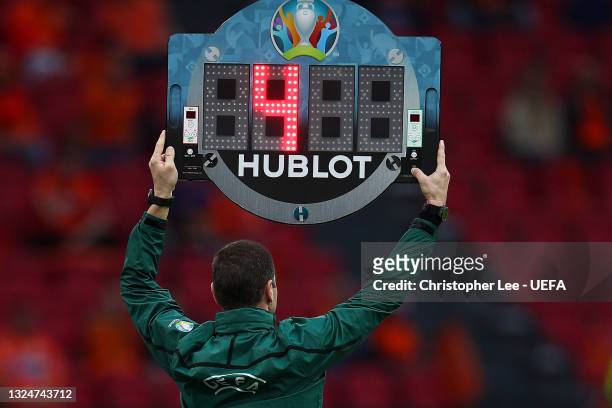 Fourth Official, Georgi Kabakov raises the substitute board indicating four minutes of added time at the end of the second half during the UEFA Euro...
