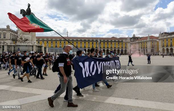 Members of Portuguese security forces wear protective masks as they march behind a Movimento Zero banner demanding better working conditions in Praça...
