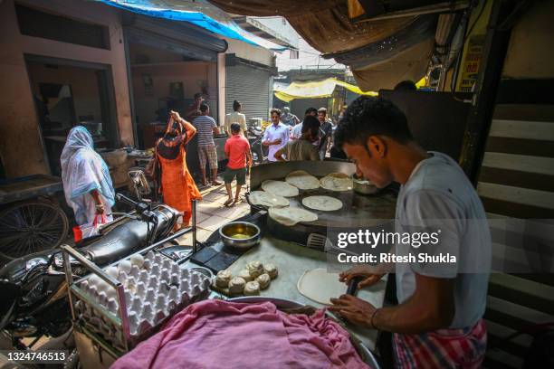 Vendor makes rotis on a street in the as Uttar Pradesh, India's most populous state, re-opens on June 21, 2021 in Varanasi, India. India has seen a...