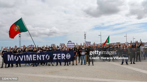 Members of Portuguese security forces wear protective masks and make the Zero gesture as they march behind a Movimento Zero banner demanding better...