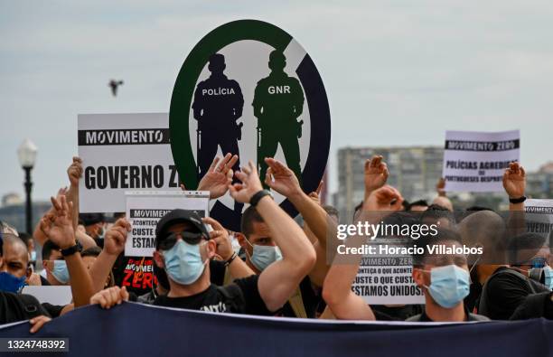 Members of Portuguese security forces wear protective masks and make the Zero gesture as they march demanding better working conditions in Praça do...