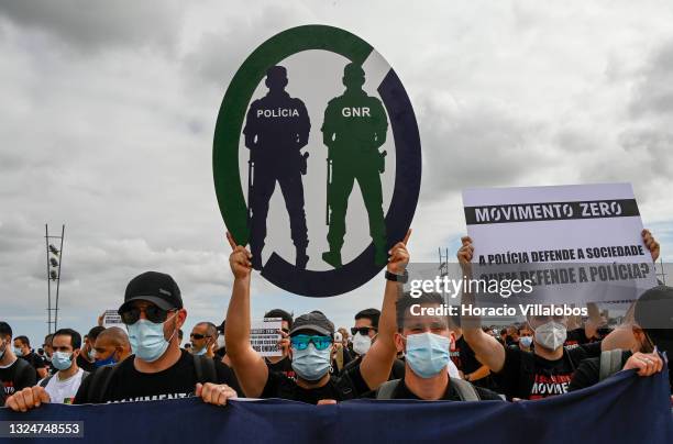 Members of Portuguese security forces wear protective masks and hoist Movimento Zero signs as they march demanding better working conditions in Praça...