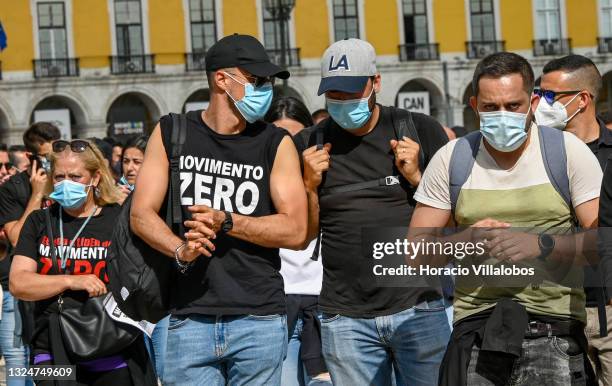 Members of Portuguese security forces wear protective masks and Movimento Zero t-shirts as they march demanding better working conditions in Praça do...