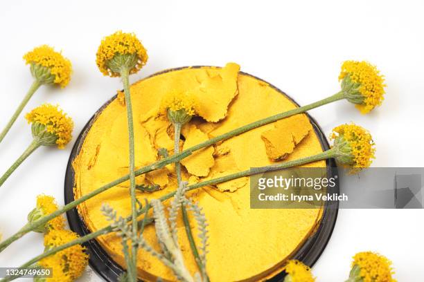 yellow flowers and beauty eyeshadow or face paint on white background. - yellow eyeshadow stock pictures, royalty-free photos & images