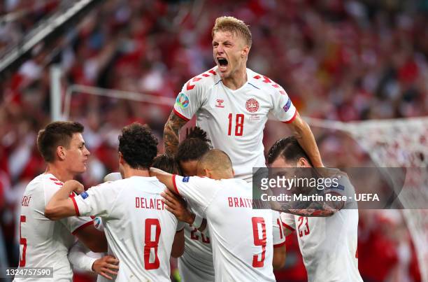 Mikkel Damsgaard of Denmark celebrates with teammates Daniel Wass, Martin Braithwaite, Joakim Maehle and Thomas Delaney after scoring their side's...