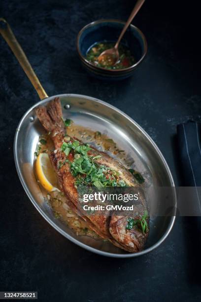 grilled sea beam with mojo isleno puerto rican sauce - mojo stock pictures, royalty-free photos & images