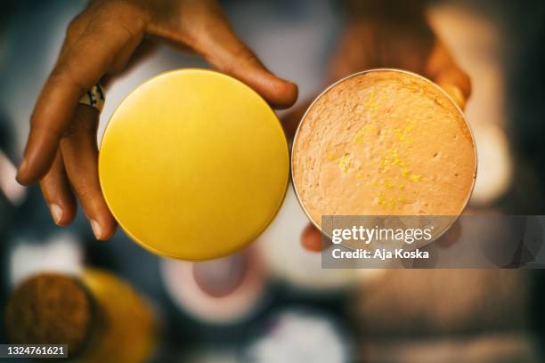 close up of unrecognizable woman holding an open face sunscreen. - shea butter stock pictures, royalty-free photos & images
