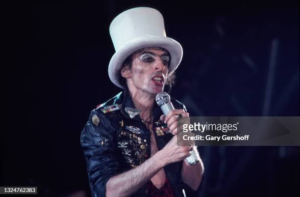 American Rock singer Alice Cooper , in a white top hat, performs onstage during the 'Flush the Fashion' tour at the Palladium, New York, New York,...