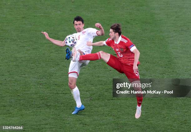 Thomas Delaney of Denmark battles for possession with Aleksei Miranchuk of Russia during the UEFA Euro 2020 Championship Group B match between Russia...