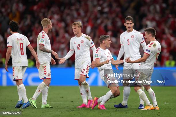 Joakim Maehle of Denmark celebrates with teammates Jens Stryger Larsen and Jannik Vestergaard after scoring their team's fourth goal during the UEFA...