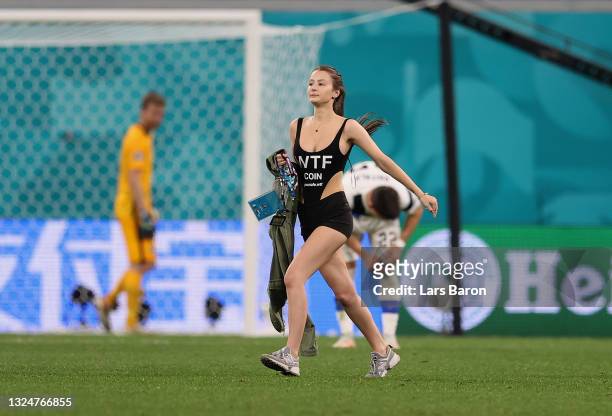 Pitch invader is seen on the pitch during the UEFA Euro 2020 Championship Group B match between Finland and Belgium at Saint Petersburg Stadium on...