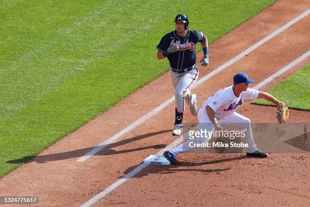 Austin Riley of the Atlanta Braves grounds out in the second inning as Pete Alonso of the New York Mets catches the ball at Citi Field on June 21,...
