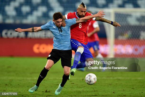 Federico Valverde of Uruguay competes for the ball with Arturo Vidal of Chile during a group A match between Uruguay and Chile as part of Conmebol...