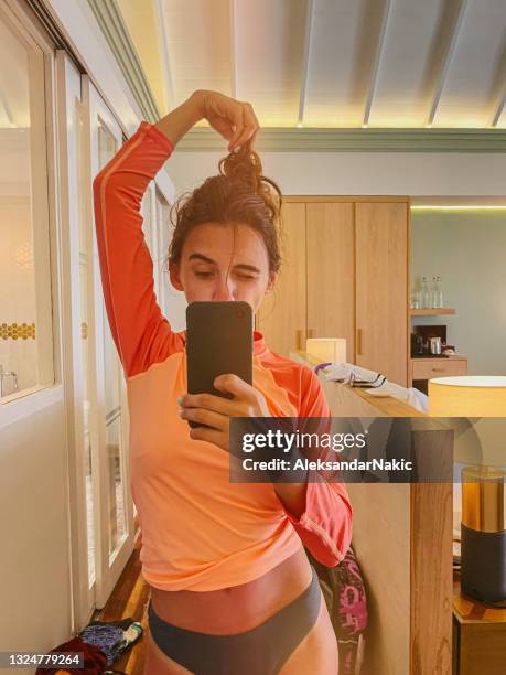 choosing my surf outfit for the day - cell phone mirror stock pictures, royalty-free photos & images