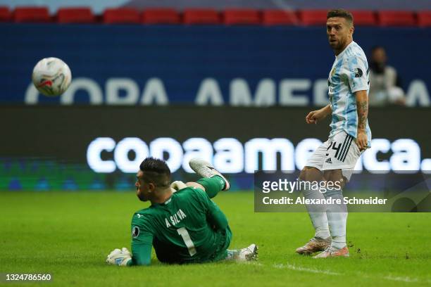 Alejandro Gomez of Argentina kicks the ball over Antony Silva goalkeeper of Paraguay to score the first goal of his team during a group A match...
