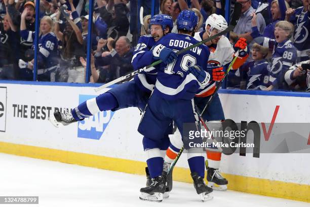 Yanni Gourde of the Tampa Bay Lightning is congratulated by Barclay Goodrow after scoring a goal against the New York Islanders during the first...