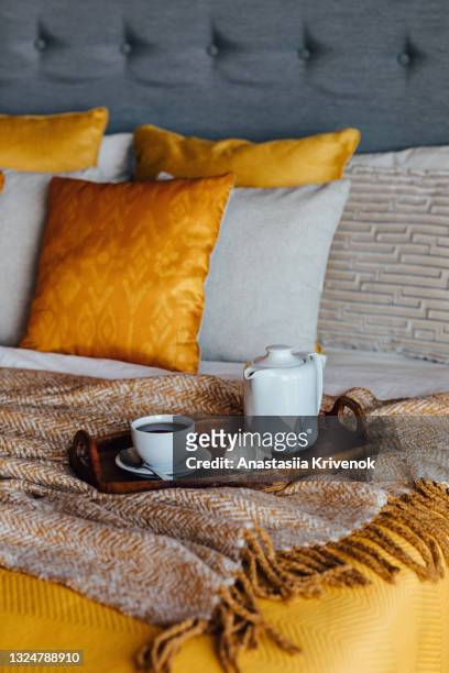 wood tray with tea on orange bed. - wool blanket stock pictures, royalty-free photos & images