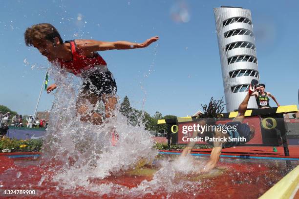 Jordan Mann falls into the water as he and Jordan Cross compete in the first round of Men's 3000 Meters Steeplechase during day four of the 2020 U.S....