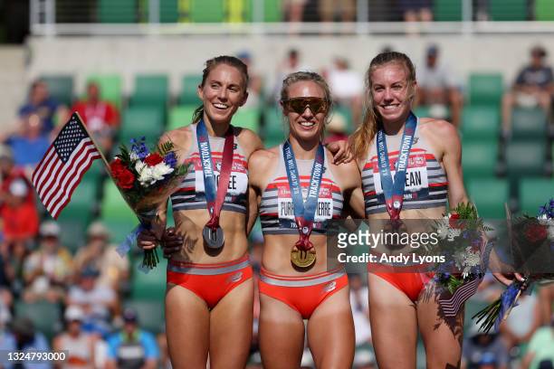Elle Purrier St. Pierre , first, Cory McGee , second, and Heather MacLean, third, celebrate on the podium after the Women's 1500 Meters Final during...