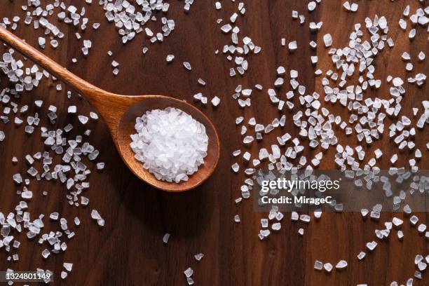 sea salt grains in wooden spoon - 塩 ストックフォトと画像