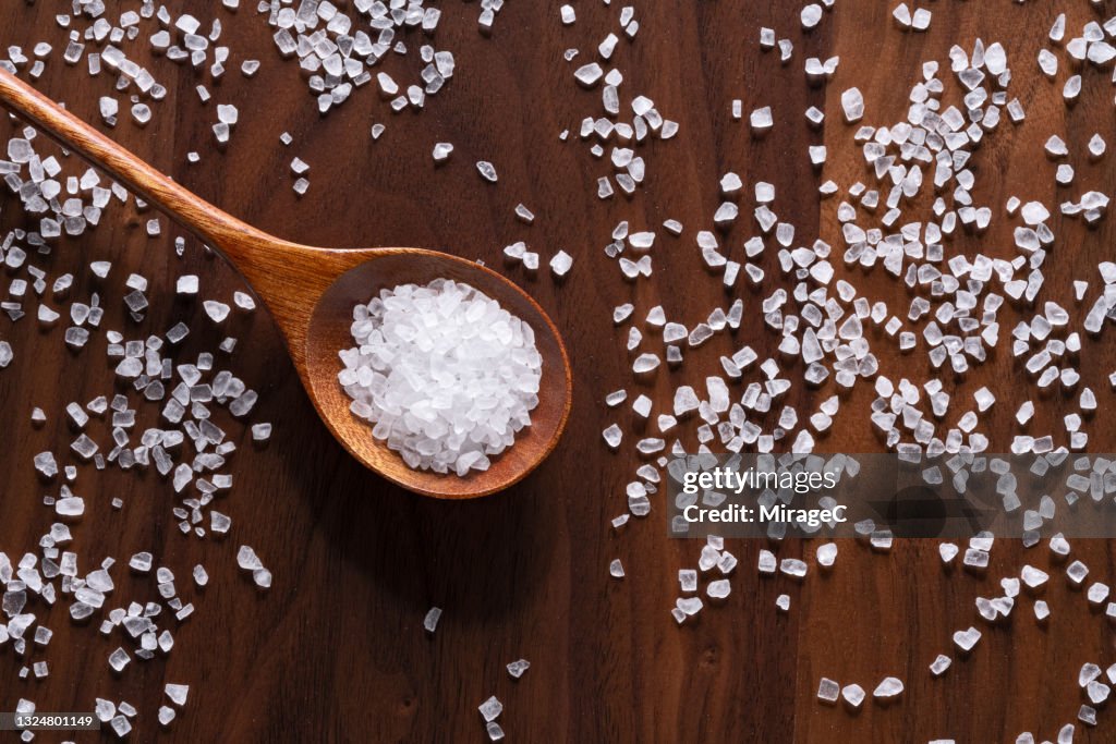 Sea Salt Grains in Wooden Spoon