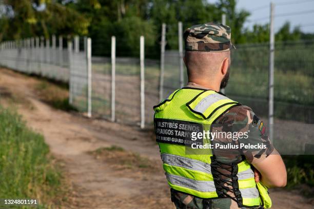 Lithuania State Border guard Vytautas Makauskas stands on patrol near the Lithuania-Belarus border line on June 21, 2021 near Poskonys, Lithuania....