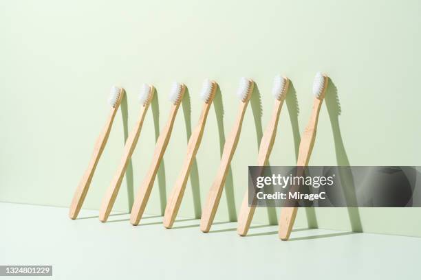 arranged bamboo wood toothbrush - toothbrush stock pictures, royalty-free photos & images