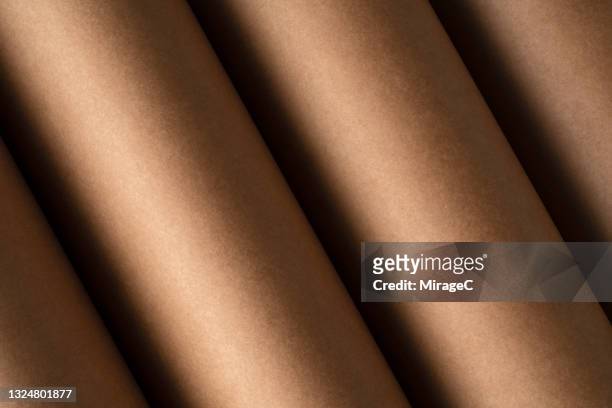 rolled brown colored kraft paper - recyclingmaterial stock-fotos und bilder