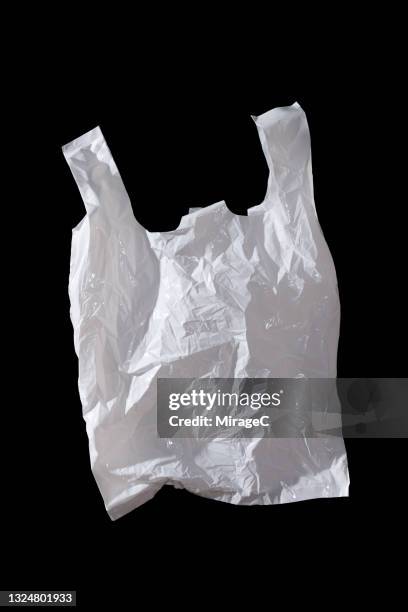 white colored plastic bag on black - plastic bag stock-fotos und bilder