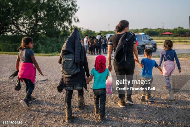 Immigrants walk towards border patrol after crossing the Rio Grande into the U.S. On June 21, 2021 in La Joya, Texas. A surge of mostly Central...