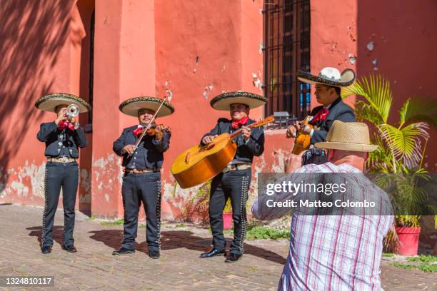 tourist and mariachi group in merida, yucatan, mexico - merida mexico stock pictures, royalty-free photos & images