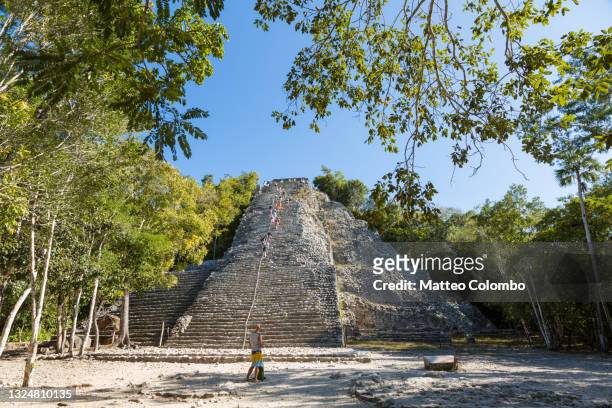tourist visiting the mayan ruins of coba, quintana roo, mexico - coba stock pictures, royalty-free photos & images