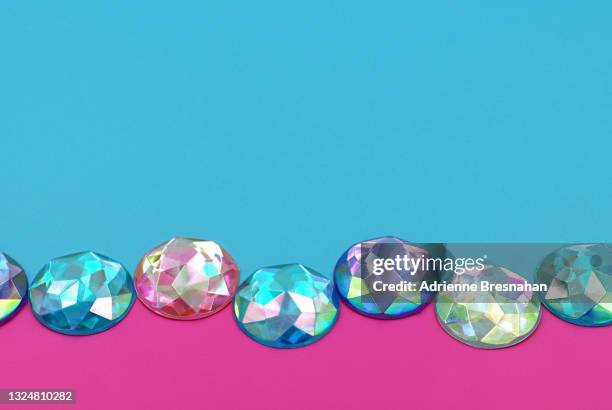 pastel colored rhinestones on pink and blue background - rhinestone stock pictures, royalty-free photos & images