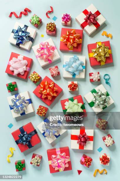 colourful gift boxes on light blue background pattern. - wrap up stock pictures, royalty-free photos & images