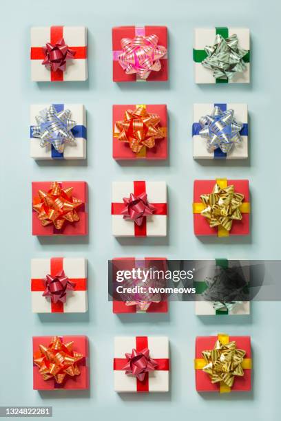 colourful gift boxes pattern on light blue background pattern. - confetti light blue background stock pictures, royalty-free photos & images