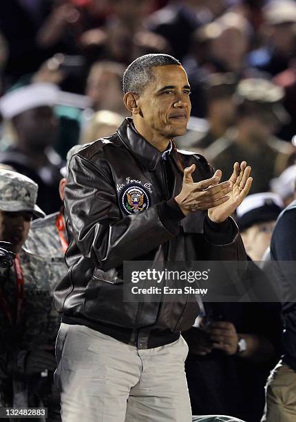 President Barack Obama claps his hands after the NCAA men's college basketball Carrier Classic between the Michigan State Spartans and the North...