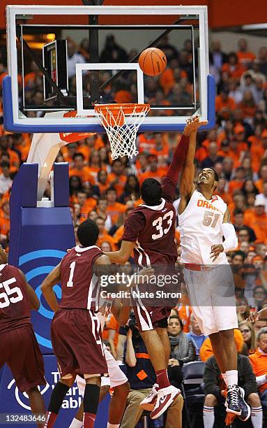 Fab Melo of the Syracuse Orange blocks the shot of Chris Gaston of the Fordham University Rams during the game at the Carrier Dome on November 12,...