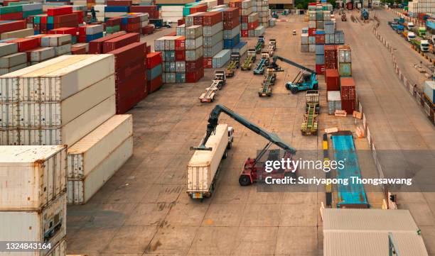 aerial top view forklift loading container to container truck in distribution warehouse for delivering to container ship, business logistics, import export shipping or freight transportation. - ships bridge 個照片及圖片檔